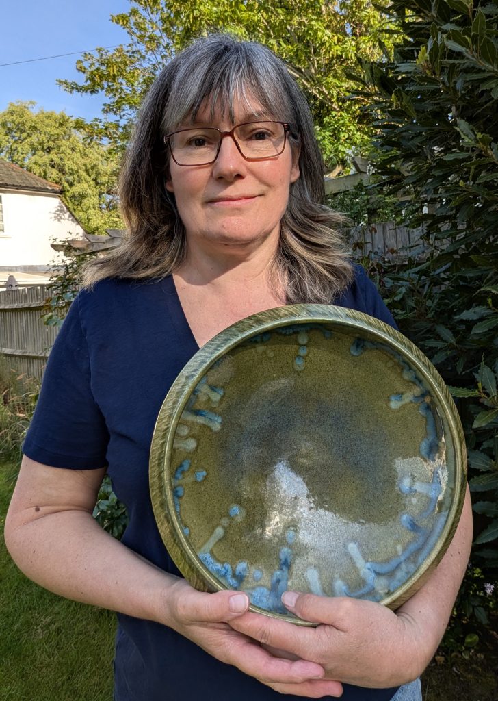 Potter hold a piece of her own work